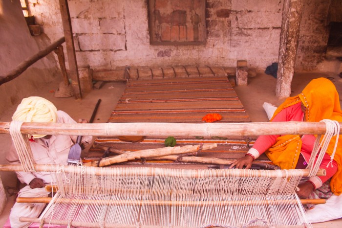 woman weaving Carpet